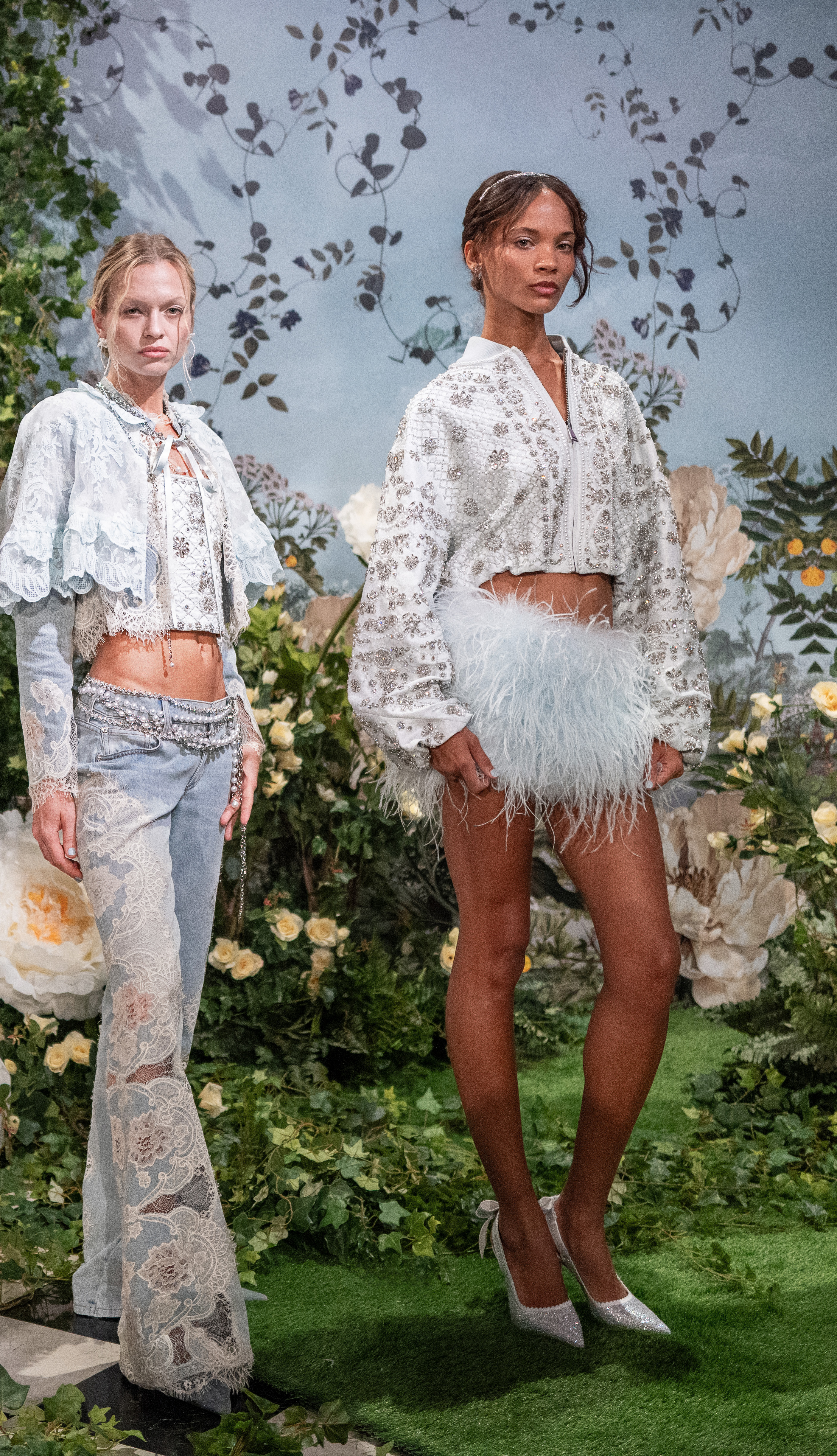 Two looks from the Wonderland collection pairing a beaded lace-and-denim ensemble with a crystal-embellished bomber jacket and ostrich-feather skirt.