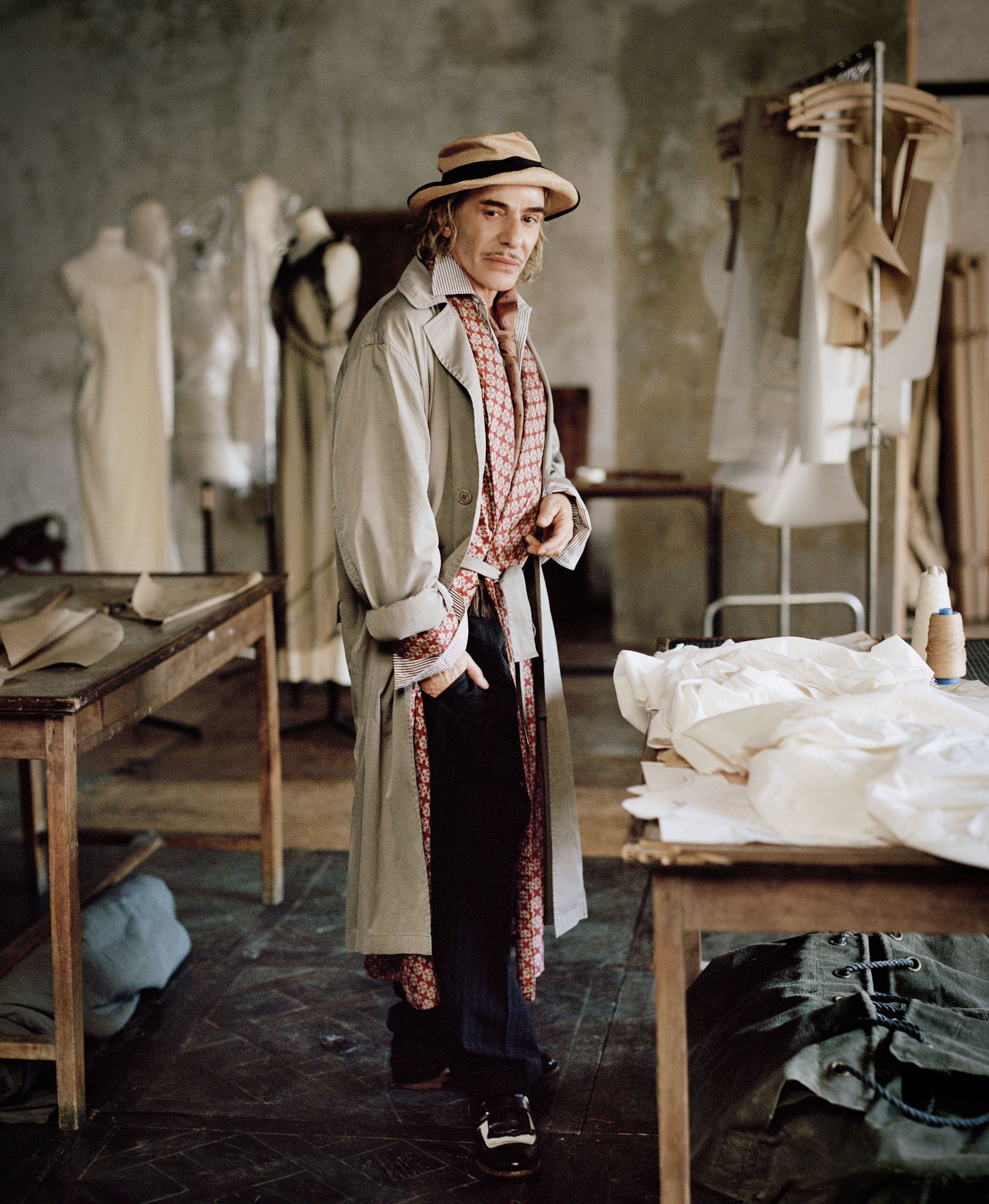Image may contain John Galliano Person Clothing Coat Adult Wedding Senior Citizen Desk Furniture and Table