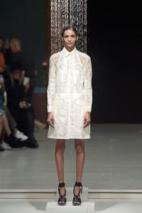 Model under a shower on the catwalk