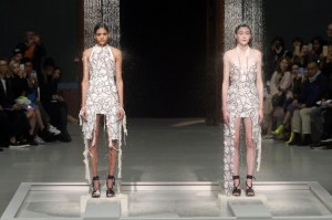 Models under a shower on the catwalk