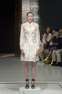 Model under a shower on the catwalk